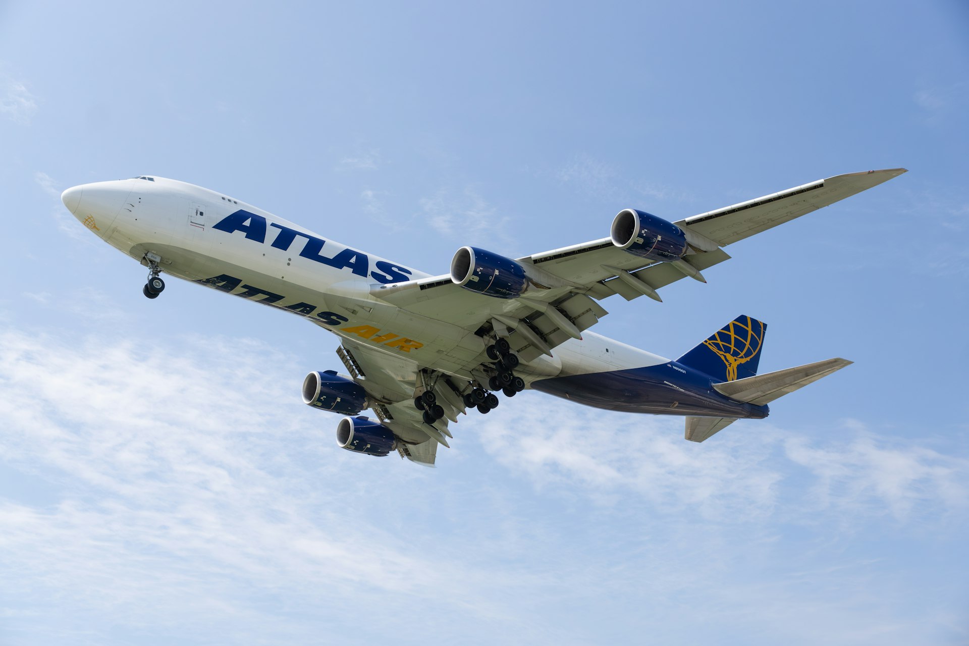 a large jetliner flying through a blue sky